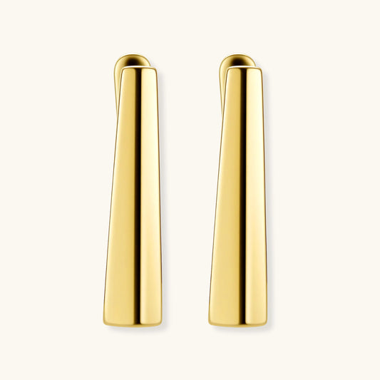 Sleek 14K gold-plated sterling silver huggie earrings with polished finish and geometric elongated design on white background.