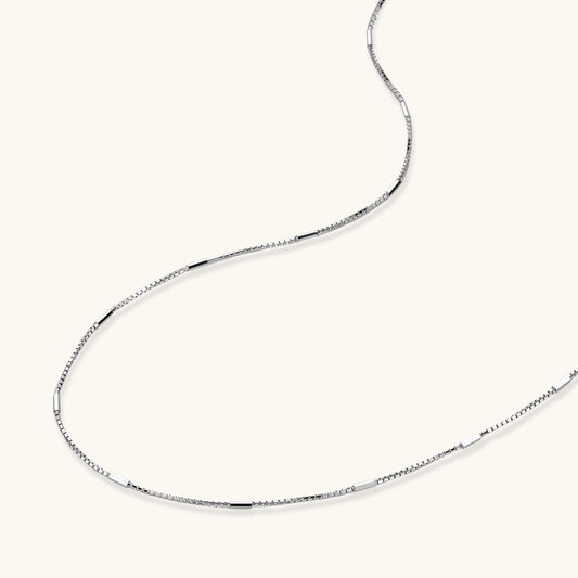 Delicate platinum-plated sterling silver necklace with alternating textured cubic links and smooth chain sections.