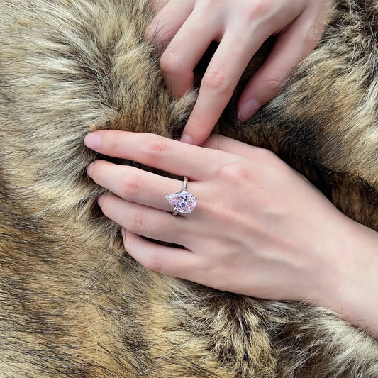 Pink teardrop solitaire silver ring, close-up on hand - Ratnali Jewels
