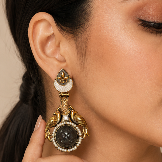 Close-up of a woman wearing an ornate gold and black earring.