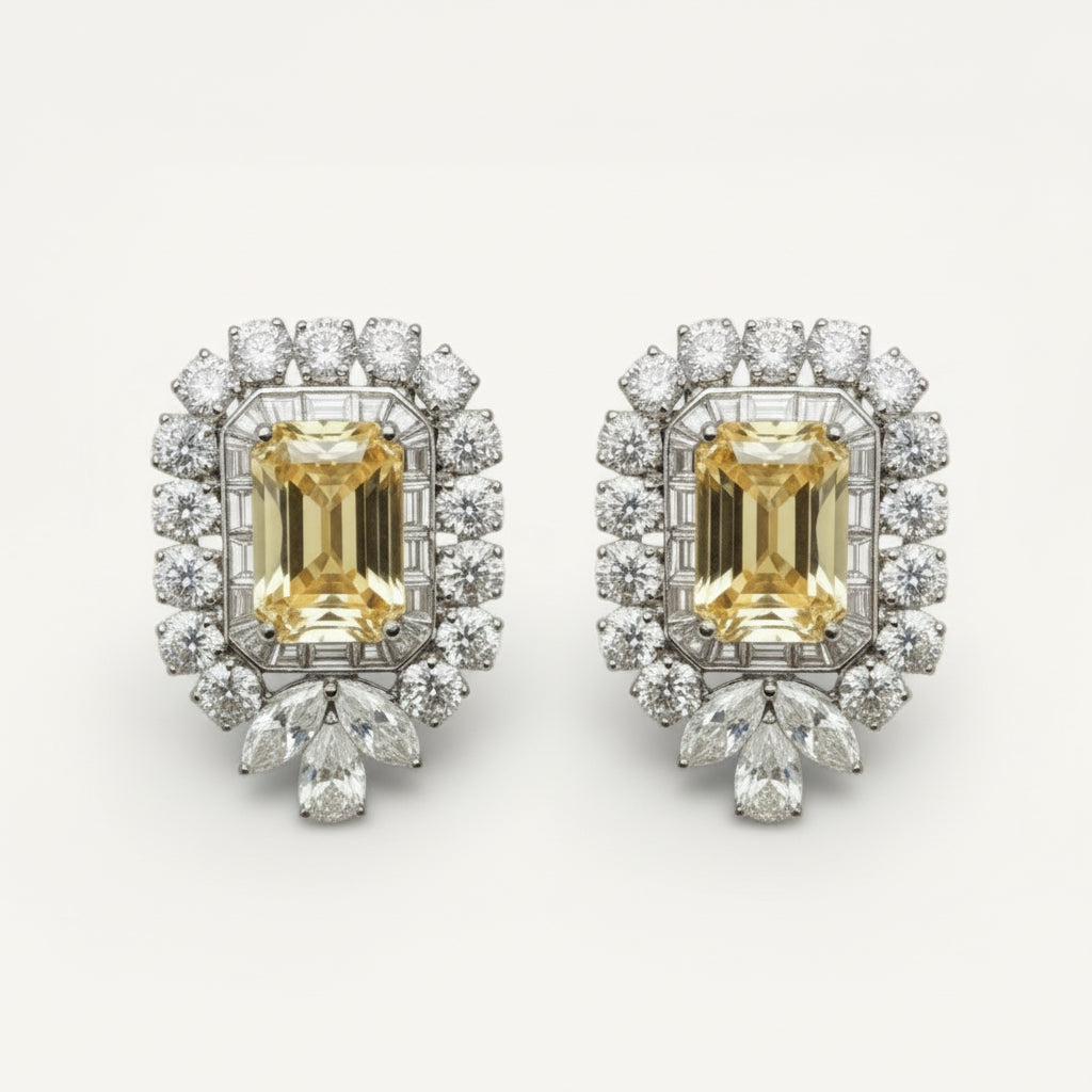 Pair of diamond earrings with yellow gemstones on a white background