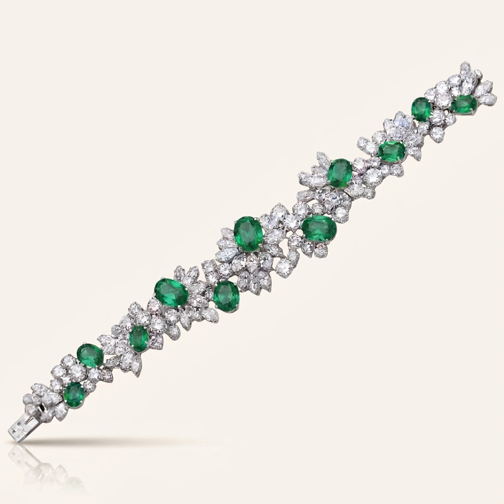 Bracelet with emeralds and diamonds on a white background