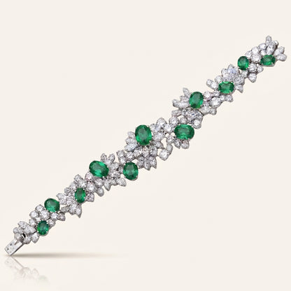 Bracelet with emeralds and diamonds on a white background