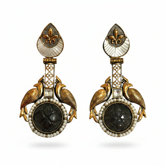 A pair of gold-plated, Egyptian style ethnic dangler earrings with faux carved ruby stones and mother-of-pearl embellishments, featuring intricate filigree framing.