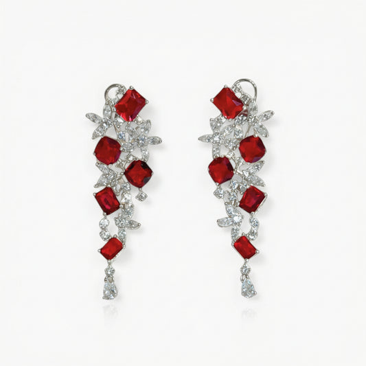 Pair of earrings with red gemstones on a white background