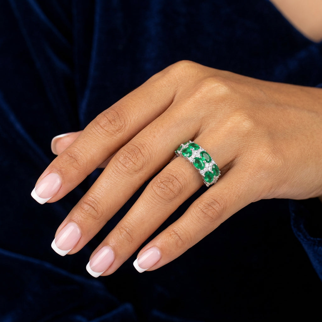 Emerald green eternity band silver ring on dark background - Ratnali Jewels