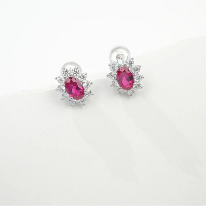 Ruby oval halo stud earrings in sterling silver
