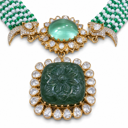 Close-up of hand-carved emerald flower pendant with Moissanite Polki halo