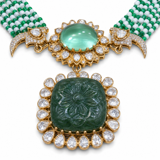 Close-up of hand-carved emerald flower pendant with Moissanite Polki halo