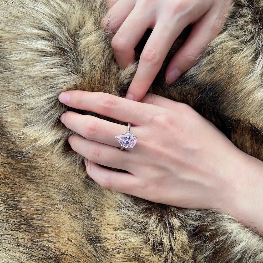 Pink teardrop solitaire silver ring, close-up on hand - Ratnali Jewels