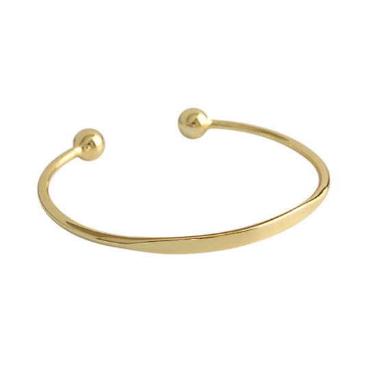 Bead End Open Bangle in 925 sterling silver. A slim adjustable band meets two polished bead ends.