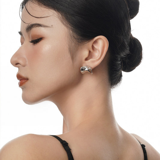 Concave Sculptural Stud Earrings in 925 sterling silver. Curved edges and dipped centres give polished studs a flowing shape.
