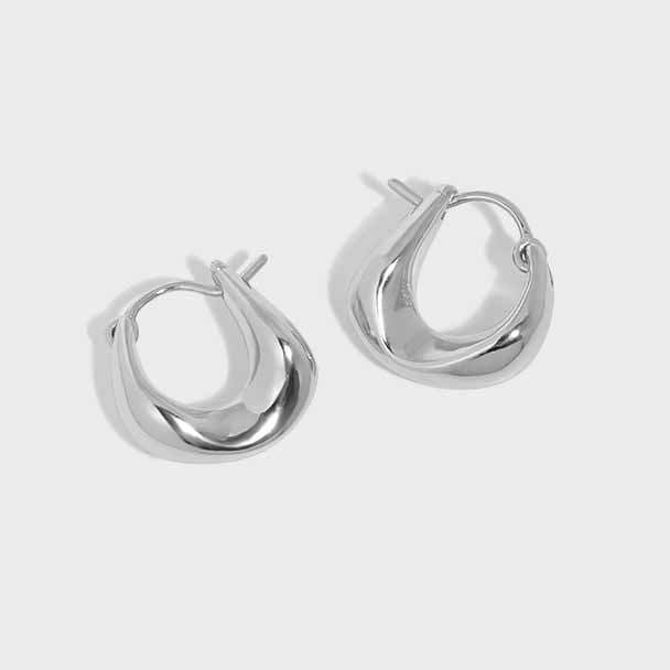 Curved Mini Hoop Earrings in 925 sterling silver. Compact curved hoops with a softly sculpted profile.