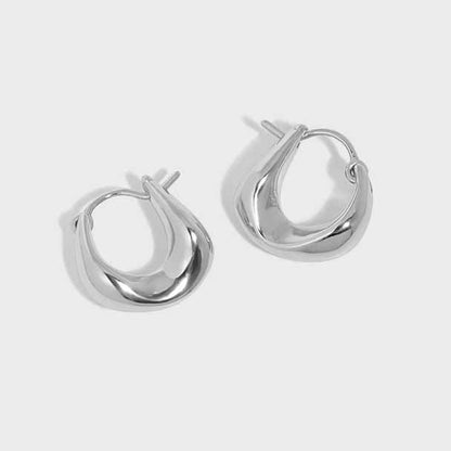 Curved Mini Hoop Earrings in 925 sterling silver. Compact curved hoops with a softly sculpted profile.