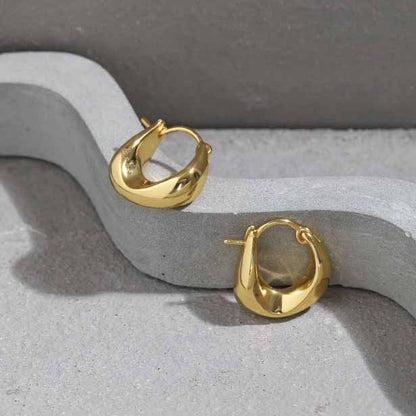 Curved Mini Hoop Earrings in 925 sterling silver. Compact curved hoops with a softly sculpted profile.