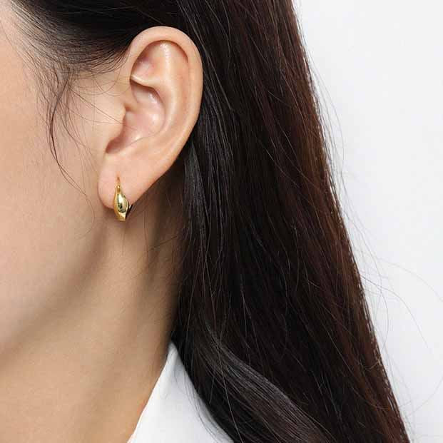 Curved Mini Hoop Earrings in 925 sterling silver. Compact curved hoops with a softly sculpted profile.