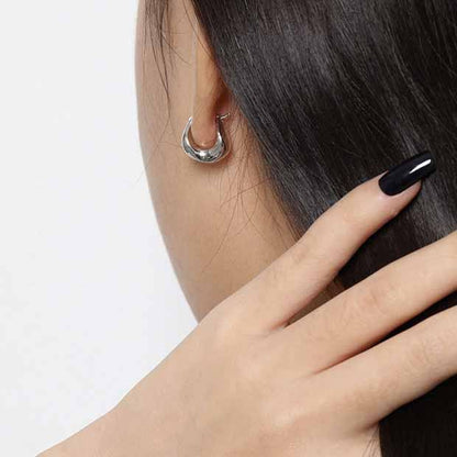 Curved Mini Hoop Earrings in 925 sterling silver. Compact curved hoops with a softly sculpted profile.