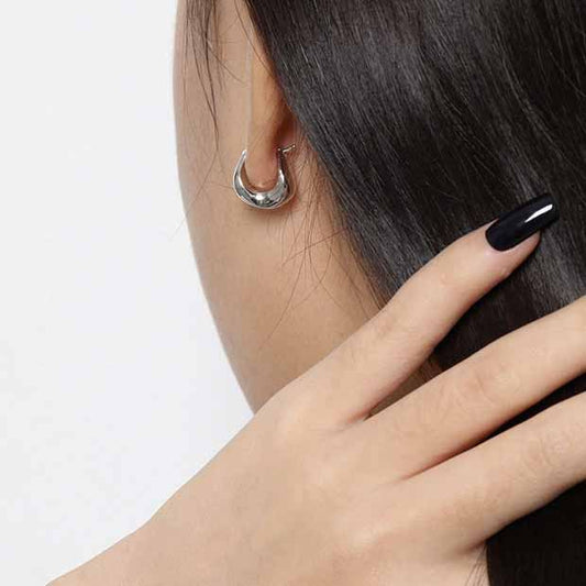 Curved Mini Hoop Earrings in 925 sterling silver. Compact curved hoops with a softly sculpted profile.