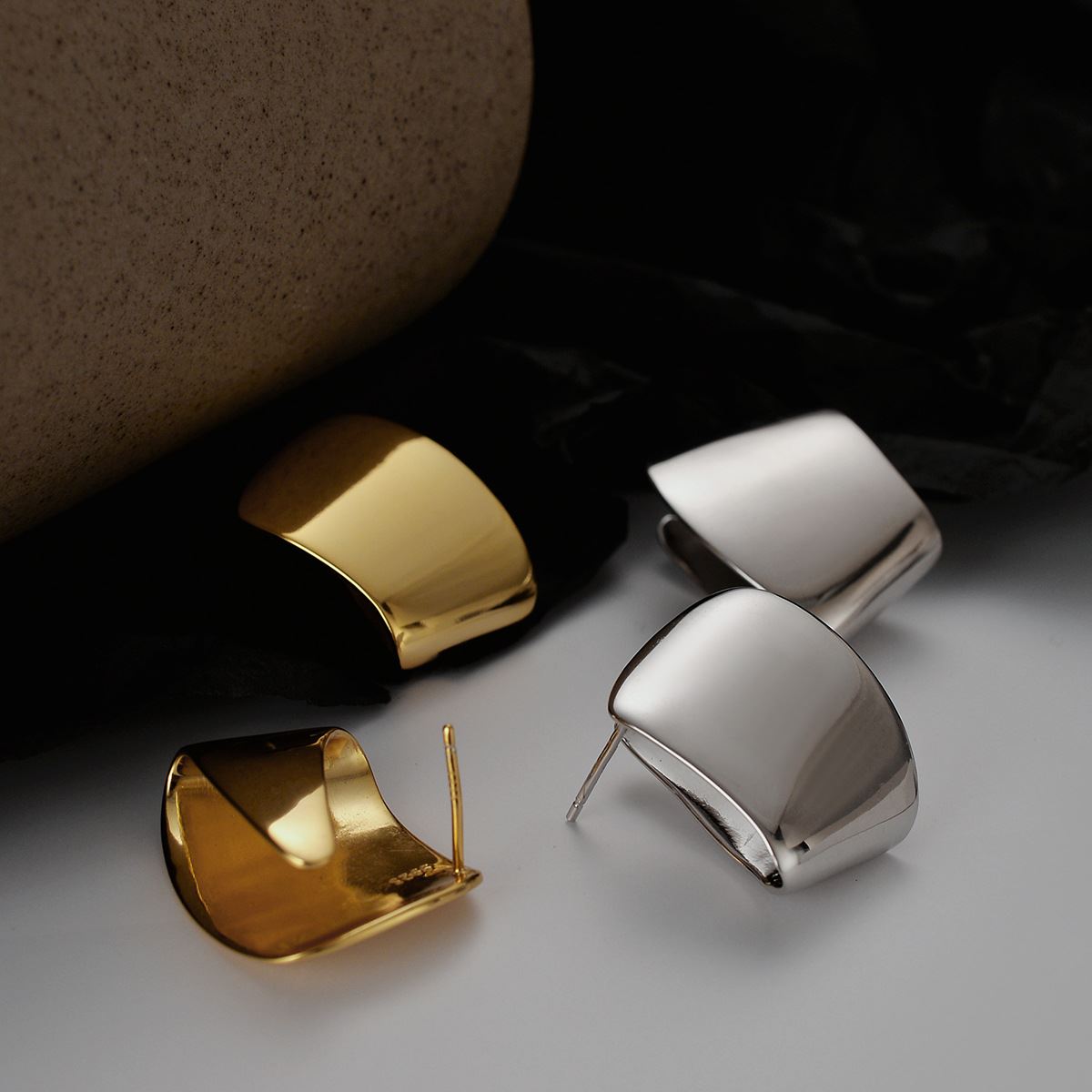 Folded Curve Stud Earrings in 925 sterling silver. Broad folded curves create an architectural polished stud.