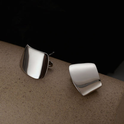 Folded Curve Stud Earrings in 925 sterling silver. Broad folded curves create an architectural polished stud.