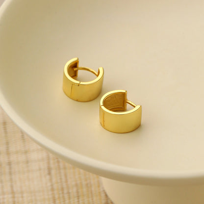 Mini Circle Huggie Earrings in 925 sterling silver. Compact circular huggies with broad polished surfaces.