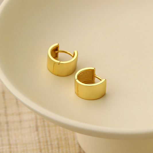 Mini Circle Huggie Earrings in 925 sterling silver. Compact circular huggies with broad polished surfaces.