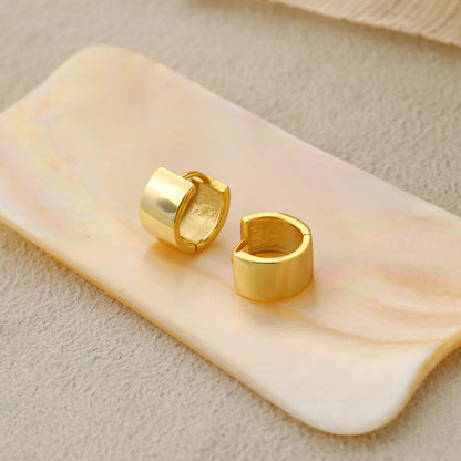 Mini Circle Huggie Earrings in 925 sterling silver. Compact circular huggies with broad polished surfaces.