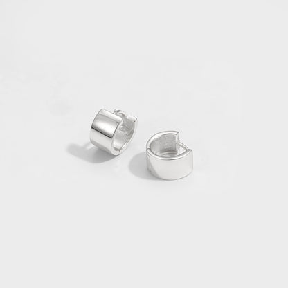 Mini Circle Huggie Earrings in 925 sterling silver. Compact circular huggies with broad polished surfaces.