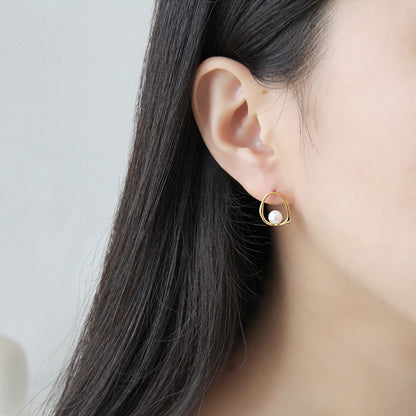 Open Oval Shell Pearl Stud Earrings in 925 sterling silver. A white shell pearl sits within a softly irregular open oval.