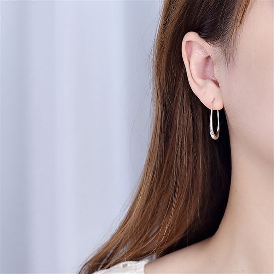 Open Teardrop Hoop Earrings in 925 sterling silver. Elongated open teardrops create a fluid outline at the ear.