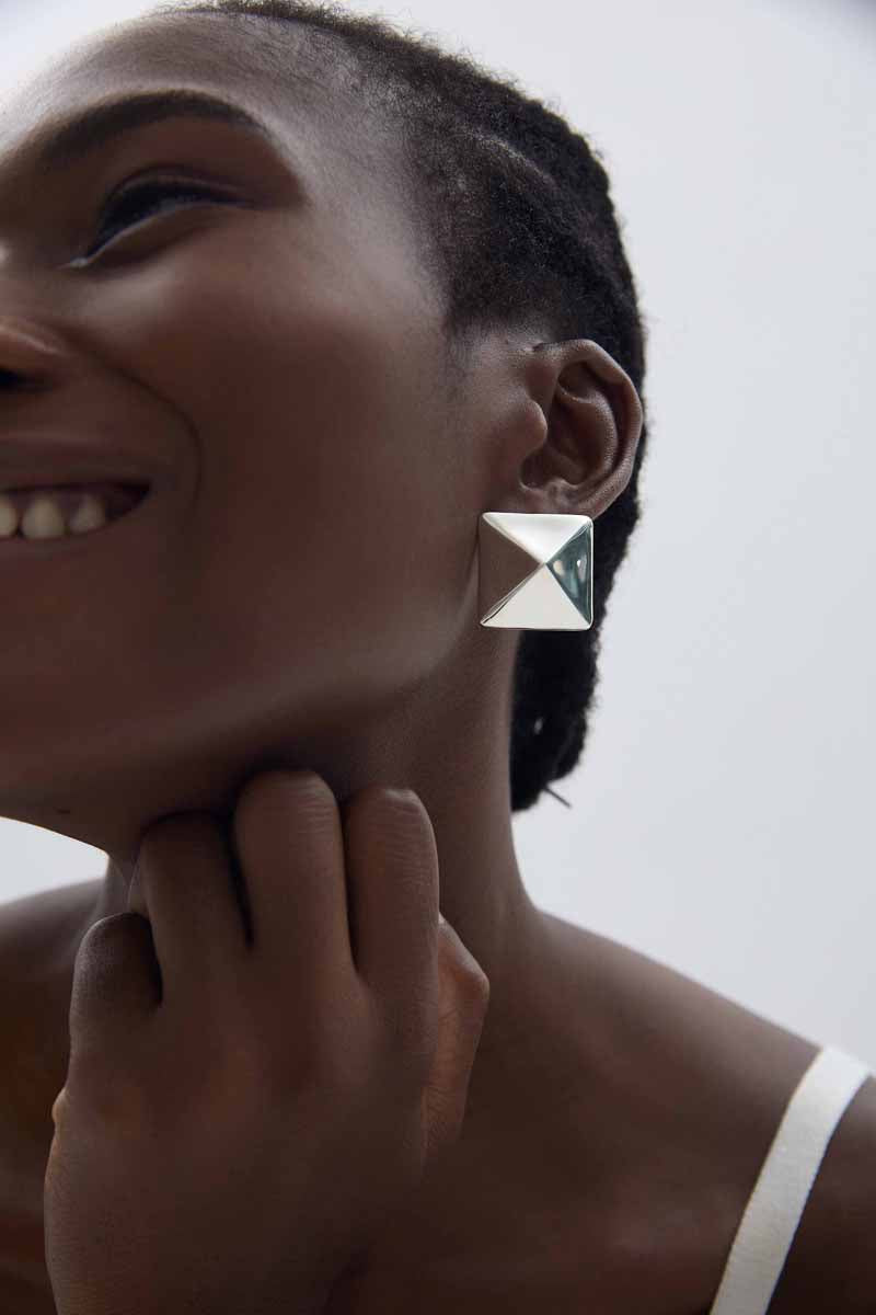 Origami Pyramid Stud Earrings in 999 fine silver. Folded planes create a geometric pyramid with crisp reflections.