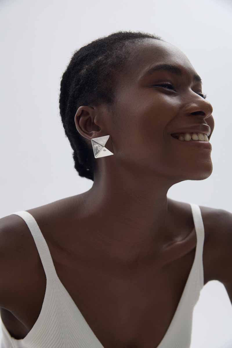 Origami Pyramid Stud Earrings in 999 fine silver. Folded planes create a geometric pyramid with crisp reflections.