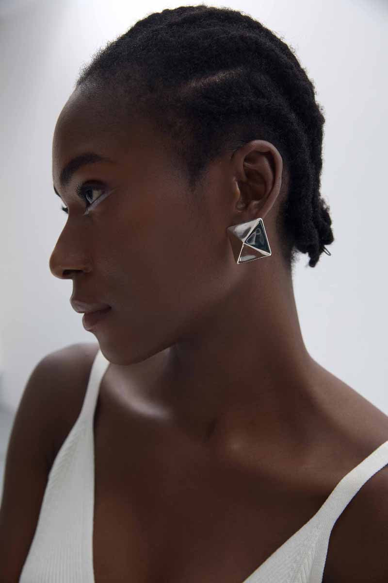 Origami Pyramid Stud Earrings in 999 fine silver. Folded planes create a geometric pyramid with crisp reflections.