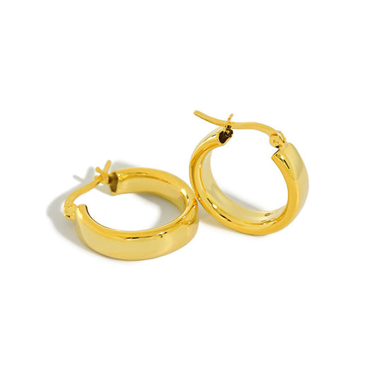 Polished Huggie Hoop Earrings in 925 sterling silver. Broad polished surfaces and hinged circular hoops for everyday wear.