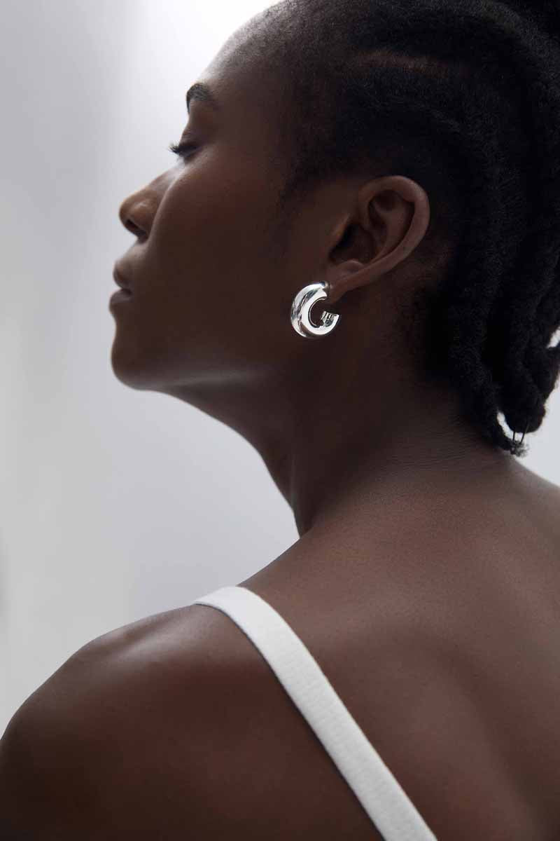 Rounded C Hoop Earrings in 999 fine silver. A tubular profile forms an open C with soft rounded edges.