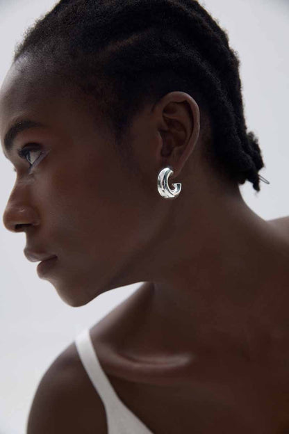 Rounded C Hoop Earrings in 999 fine silver. A tubular profile forms an open C with soft rounded edges.