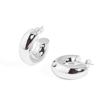 Rounded C Hoop Earrings in 999 fine silver. A tubular profile forms an open C with soft rounded edges.
