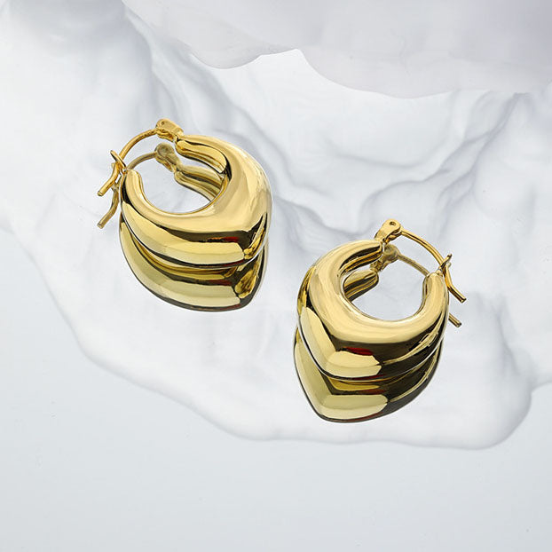 Rounded U Hoop Earrings in 925 sterling silver. Full rounded U curves bring a sculptural finish to everyday hoops.