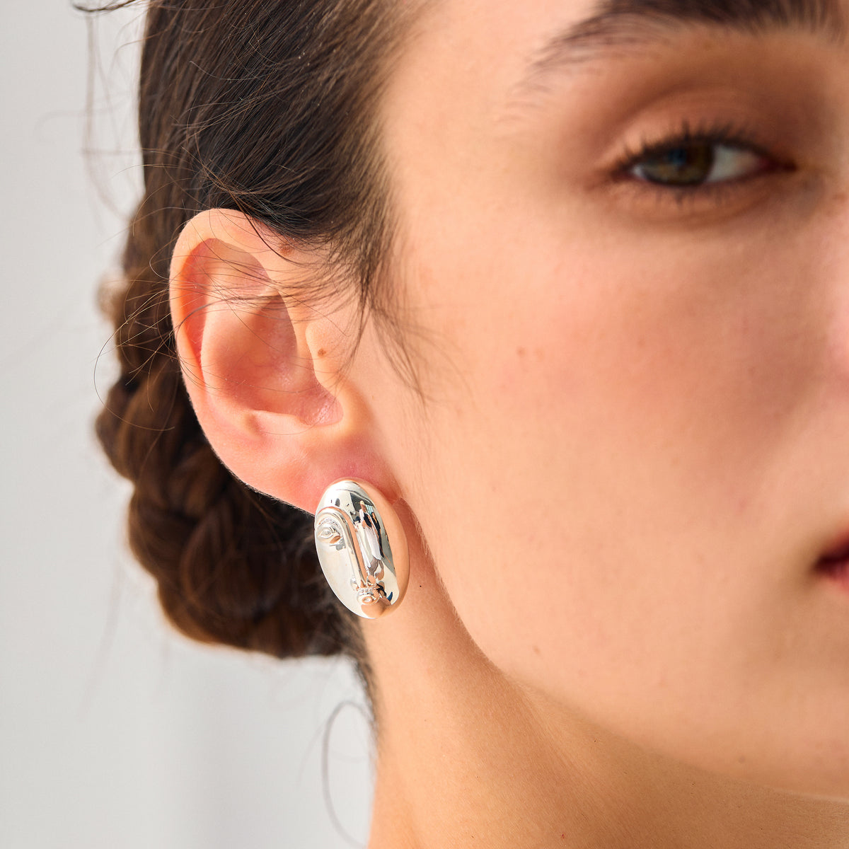 Sculpted Oval Stud Earrings in 999 fine silver. Elongated organic ovals with a reflective sculpted surface.