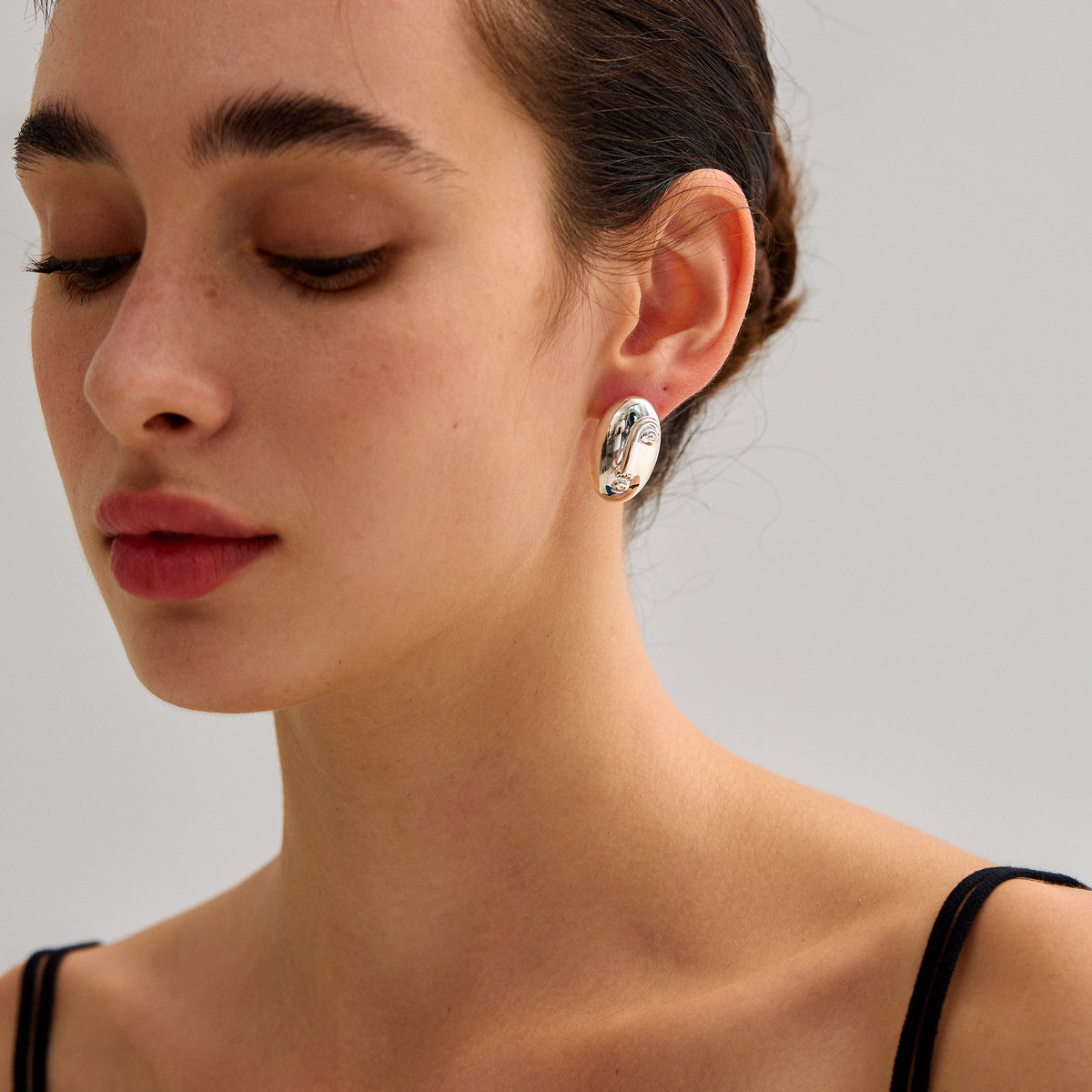 Sculpted Oval Stud Earrings in 999 fine silver. Elongated organic ovals with a reflective sculpted surface.