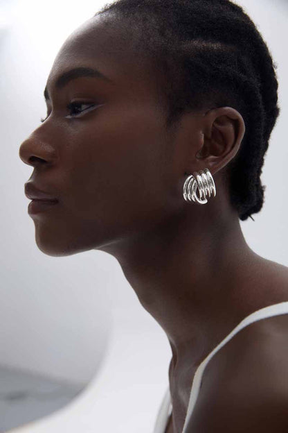 Sculptural Cross Stud Earrings in 999 fine silver. Rounded intersecting forms create a bold sculptural cross.