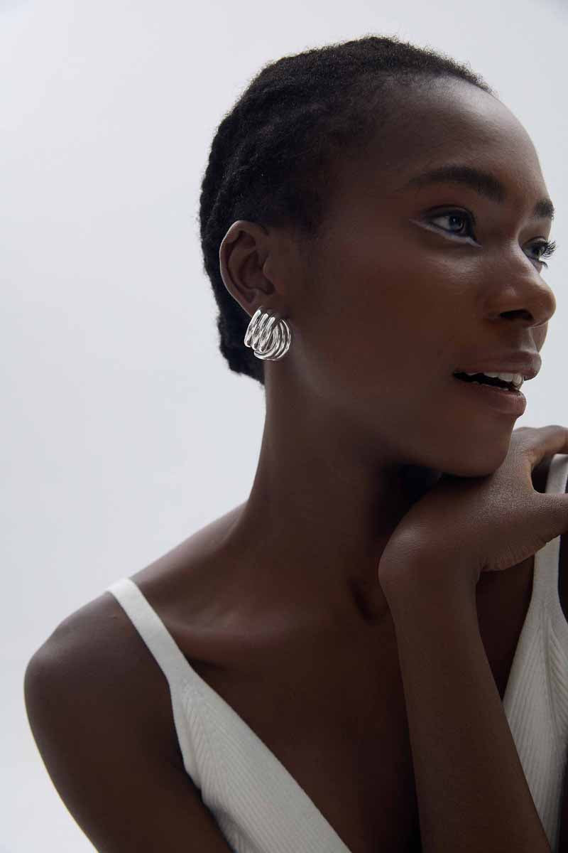 Sculptural Cross Stud Earrings in 999 fine silver. Rounded intersecting forms create a bold sculptural cross.