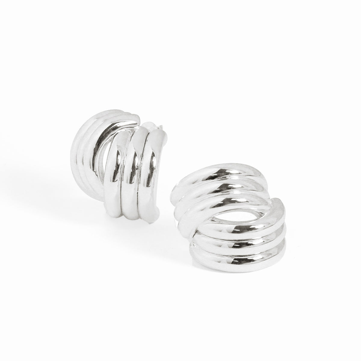 Sculptural Cross Stud Earrings in 999 fine silver. Rounded intersecting forms create a bold sculptural cross.