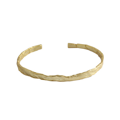 Textured Open Cuff Bangle in 925 sterling silver. An open cuff with an uneven surface that catches the light.