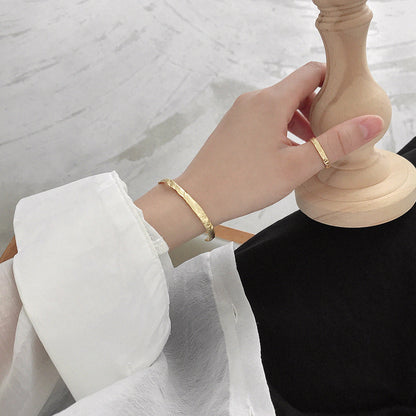 Textured Open Cuff Bangle in 925 sterling silver. An open cuff with an uneven surface that catches the light.