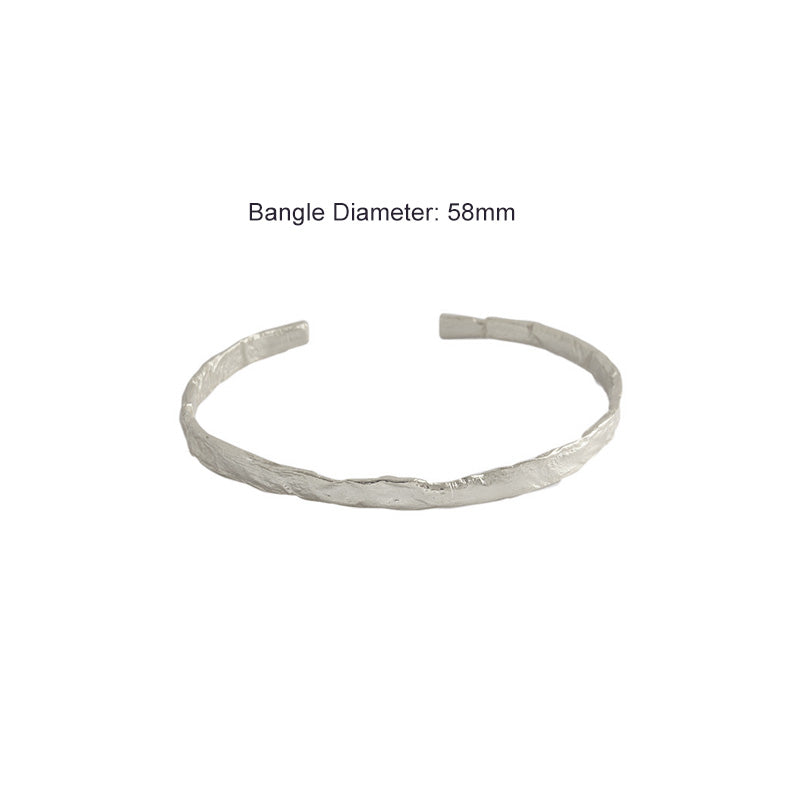 Textured Open Cuff Bangle in 925 sterling silver. An open cuff with an uneven surface that catches the light.
