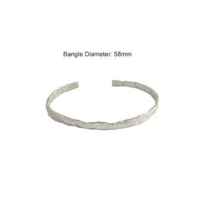 Textured Open Cuff Bangle in 925 sterling silver. An open cuff with an uneven surface that catches the light.