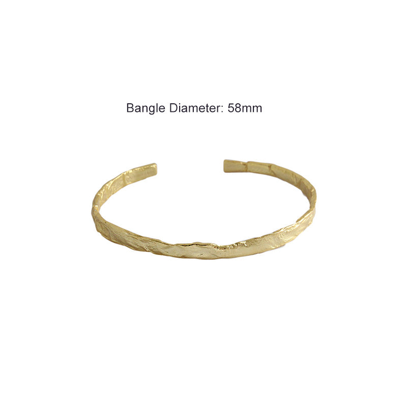 Textured Open Cuff Bangle in 925 sterling silver. An open cuff with an uneven surface that catches the light.