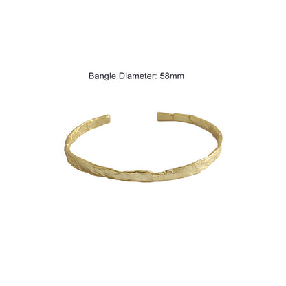 Textured Open Cuff Bangle in 925 sterling silver. An open cuff with an uneven surface that catches the light.