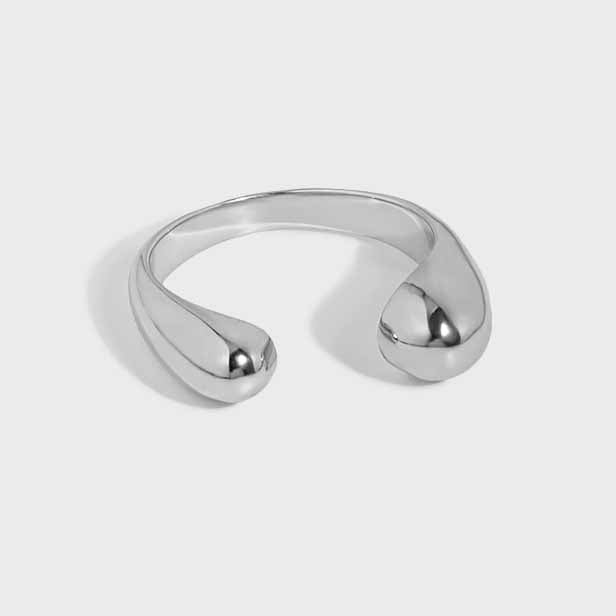 Twin Teardrop Open Ring in 925 sterling silver. Two rounded teardrop ends curve towards each other in an open band.